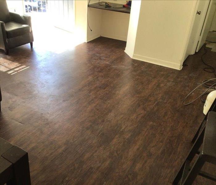 Newly installed hardwood floors in a living room.